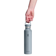 Person holding a light blue water bottle with a white background
