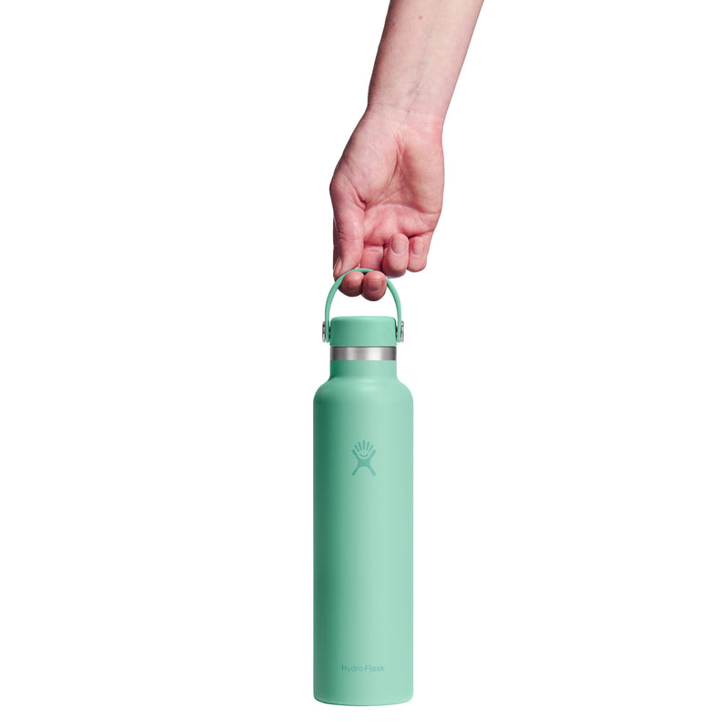 Mint green water bottle held by a hand on a white background