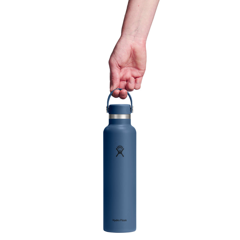 Blue water bottle held by a hand on a white background