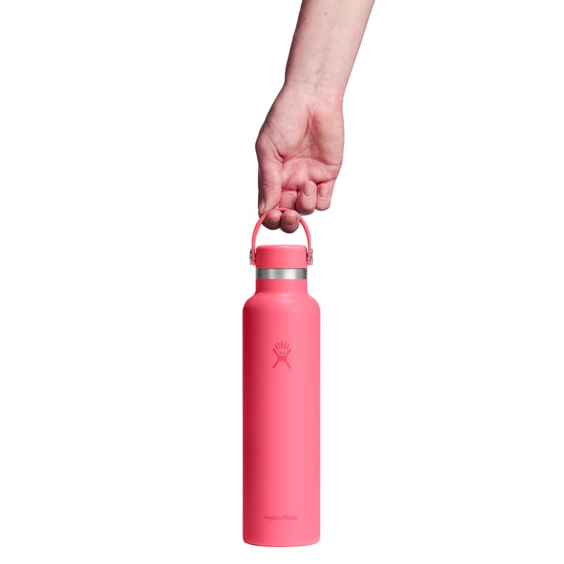 Pink water bottle held by a hand on a white background