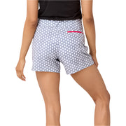 Person wearing gray shorts with white starburst polka dots and a red pocket trim on a white background