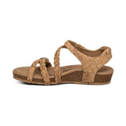The side of a brown cork sandal on a white background