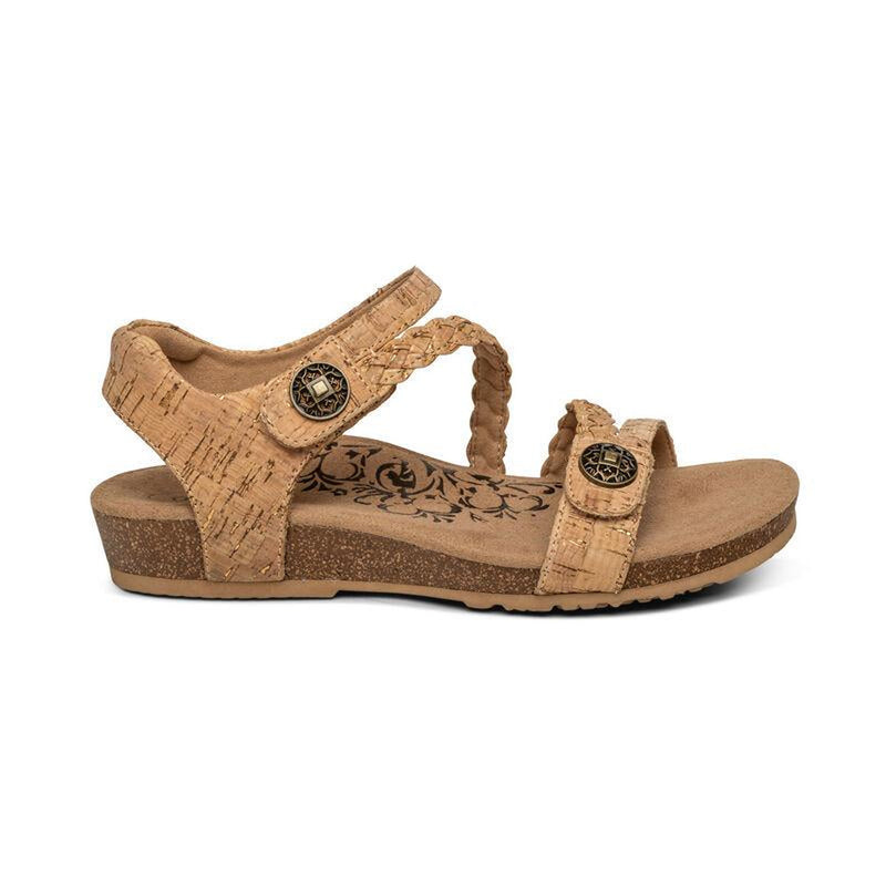 The side of a brown cork sandal on a white background