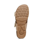 The bottom of a brown cork sandal on a white background