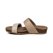 The side of a brown cork sandal with 2 gray straps on a white background