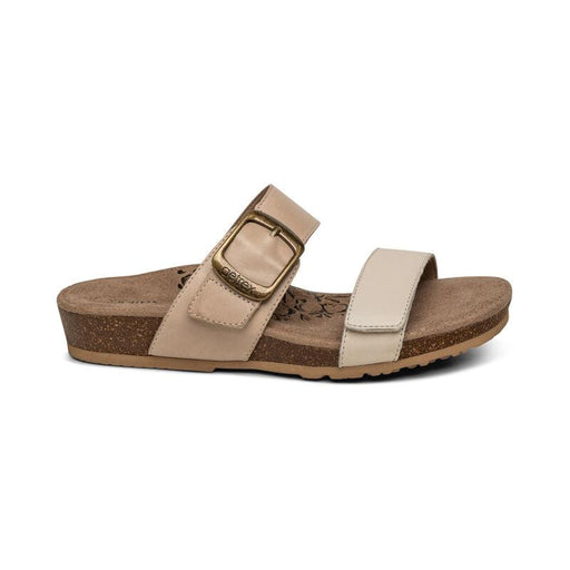 The side of a brown cork sandal with 2 gray straps on a white background