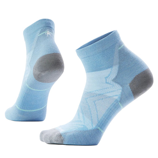 Pair of light blue socks with gray toes and heels on a light gray background