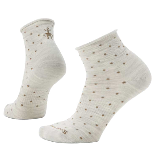 Pair of beige socks with small brown dots on a white background