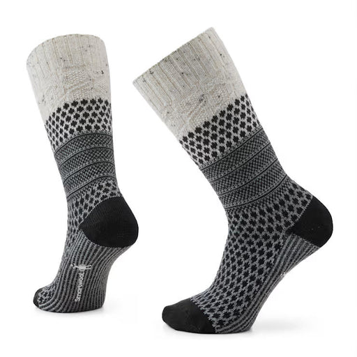Pair of gray socks with black pattern and sole on a white background