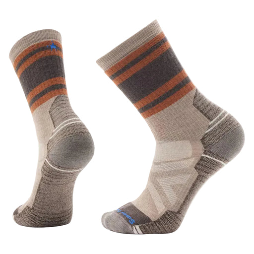Pair of gray socks with brown and blue stripes on a light gray background