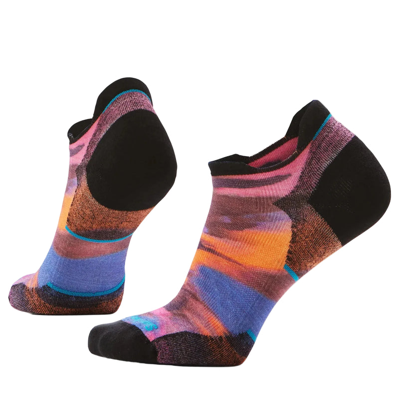 Colorful socks with black toes and heels on a light gray background