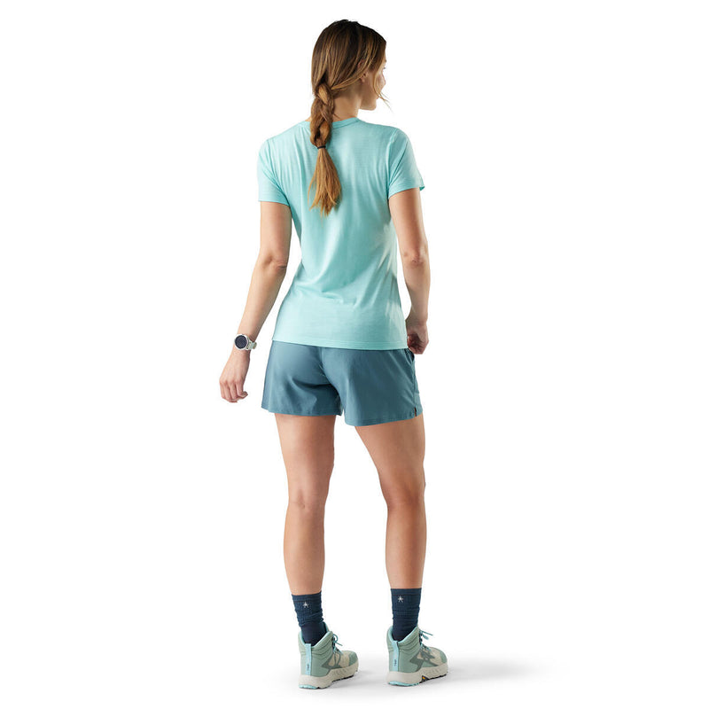 Woman wearing a light blue athletic outfit on a white background