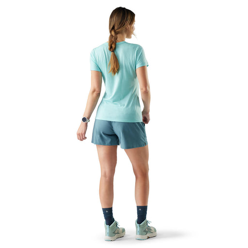 Woman wearing a light blue athletic outfit on a white background
