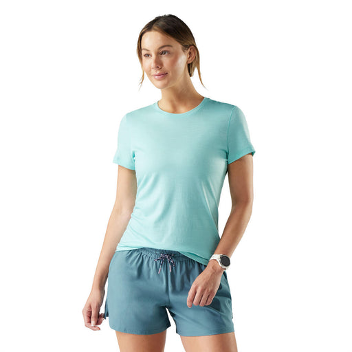Woman wearing a light blue t-shirt and shorts on a white background
