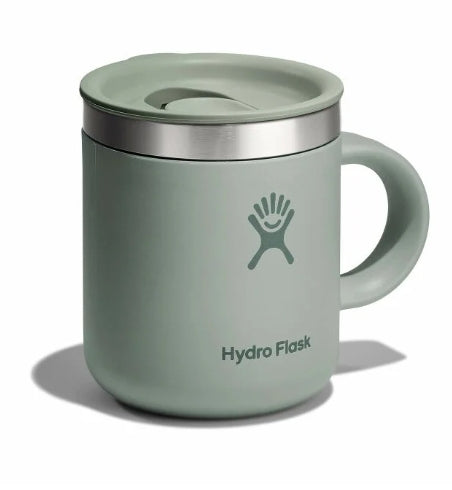 Side view of a light green travel mug with a Hydroflask logo on it on a white background.