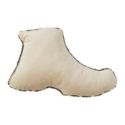 Cream colored boot shaped pillow against a white background. 