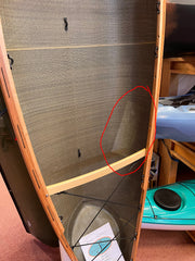 Carbon-kevlar canoe with cherry wood gunwales, close-up of hull interior to show a patch. 