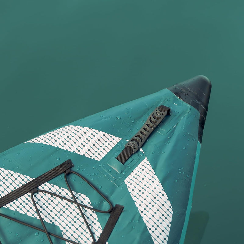 Front end of a blue kayak with white accents in a lake. 