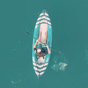 Aerial view of a man paddling down a river in a blue and white kayak.