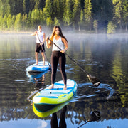 Man and woman rowing down a river on their blue and yellow paddleboards.