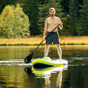 Man standing on a yellow and blue paddleboard in a lake. 