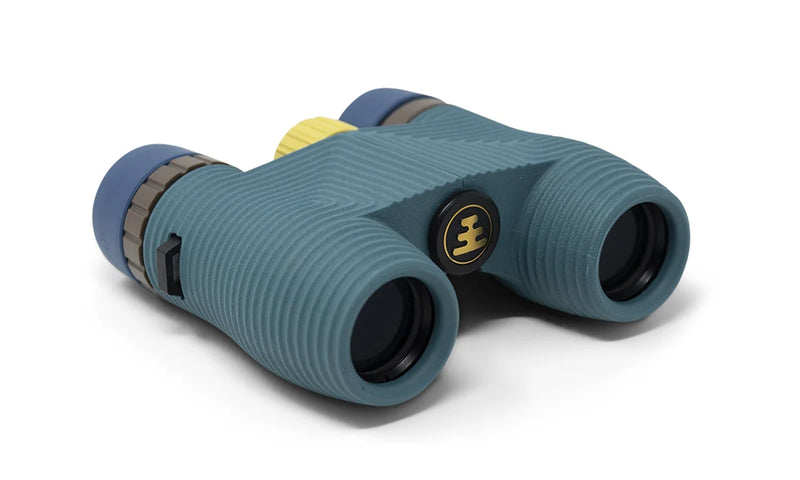 A blue pair of binoculars with a yellow dial on a white background