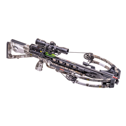 A crossbow with a black and gray camo stock, limbs, and riser, featuring a mounted scope and a black quiver attached to the front, shown against a plain white background.