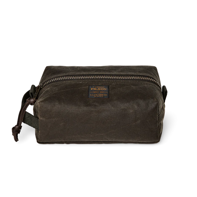 Dark green travel bag with Filson logo against a white background. 
