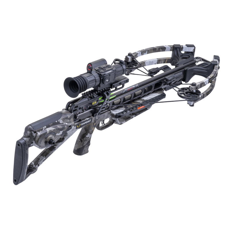 A crossbow with a gray and black digital camouflage pattern, featuring an attached scope, photographed on a solid white background.