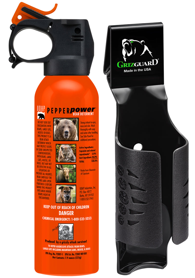 Orange can of bear spray featuring pictures of various animals next to a black holster against a white background.