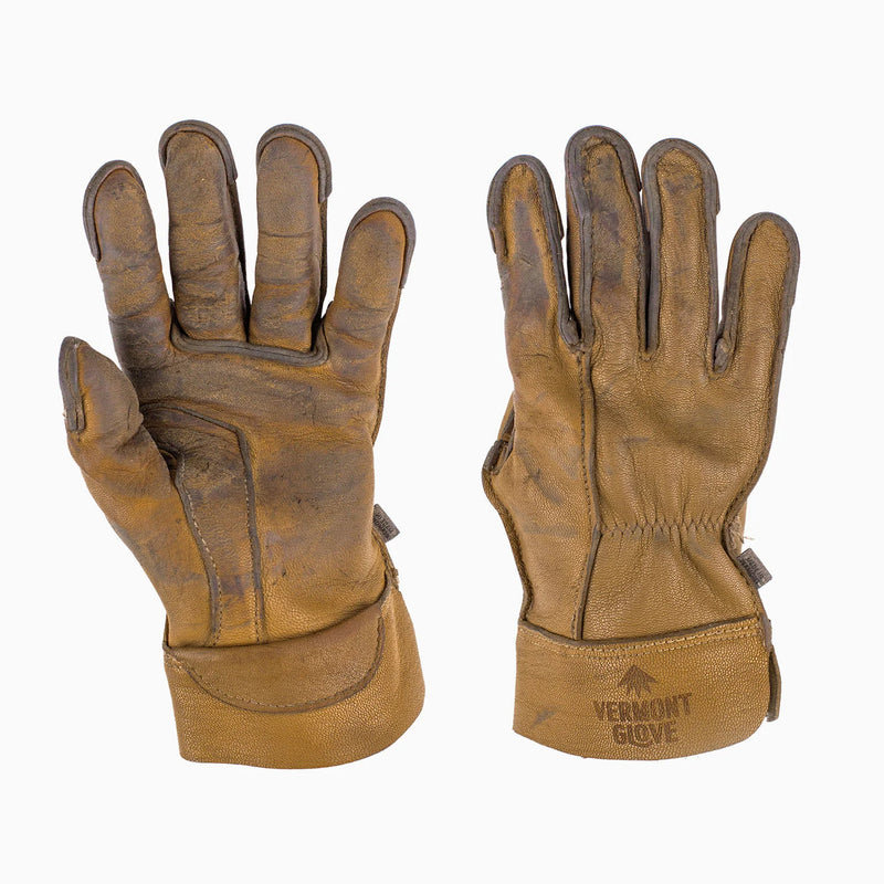 A pair of vintage brown leather work gloves shown against a plain white background, displaying both the back of one glove and the palm/interior of the other. The brand 'Vermont Glove' is embossed on the cuff.