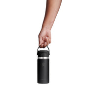 A hand holding the handle of a black Hydro Flask insulated water bottle against a solid white background.