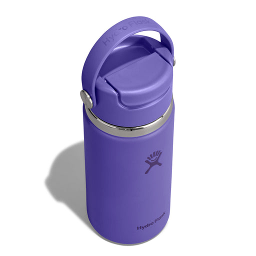 A purple Hydro Flask insulated water bottle with a matching purple flip-top lid and carry loop, shown on a white background with a soft shadow.