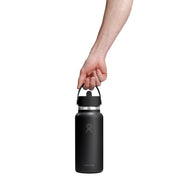 Black water bottle held by a hand on a white background