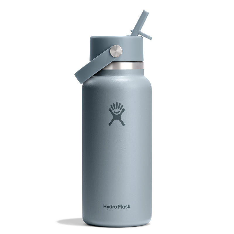 A matte slate blue Hydro Flask insulated water bottle with a matching lid, carrying loop, and straw, shown on a clean white background.