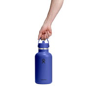 Blue Hydro Flask water bottle held by a hand on a white background