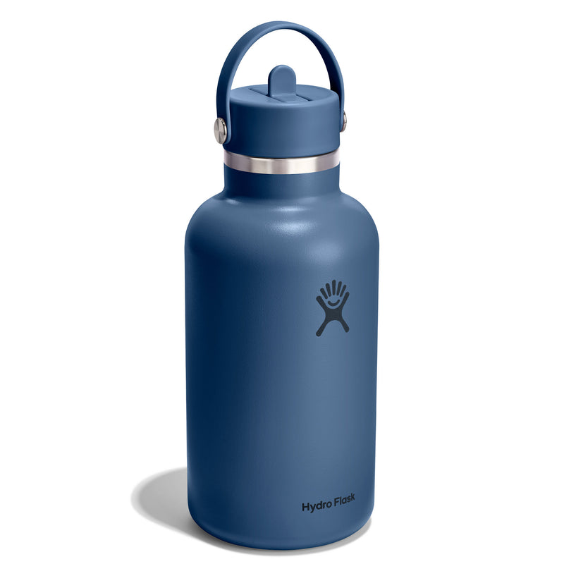 A HydroFlask insulated water bottle in a matte slate blue color, featuring a matching blue lid with a carry loop and a silver stainless steel band around the neck. The HydroFlask logo is printed in black on the front, and the brand name is visible near the bottom.