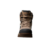 A single FXD mid-top work boot in tan and black, shown from the front against a dark background with a blue glow at the base.