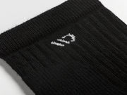 Black sock with a logo on a light gray background