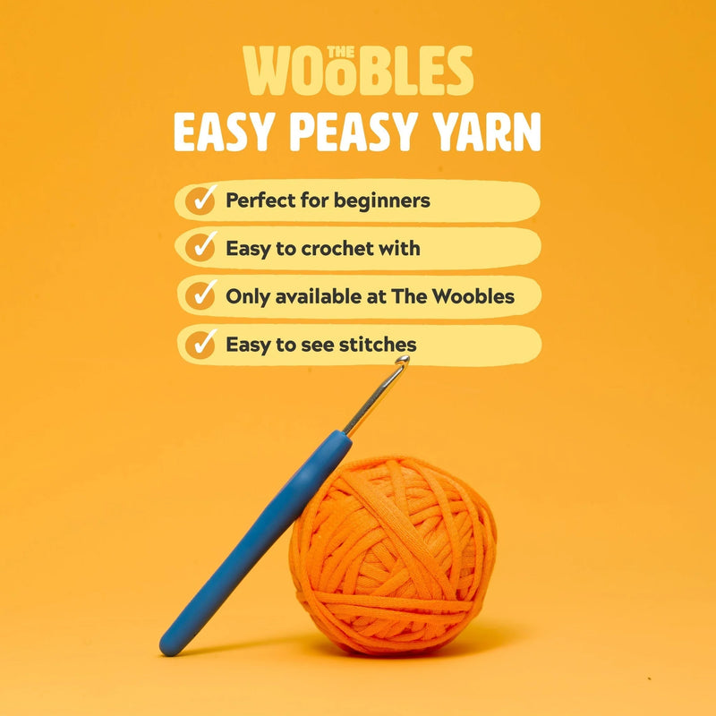 Orange yarn ball with blue crochet hook on an orange background with 'The Woobles' branding.