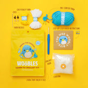 Crochet kit with yarn, needle, hook, and instructions on a yellow background