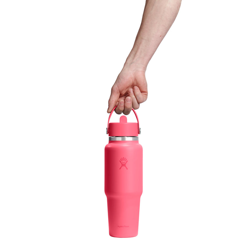 Person holding a pink water bottle with a white background