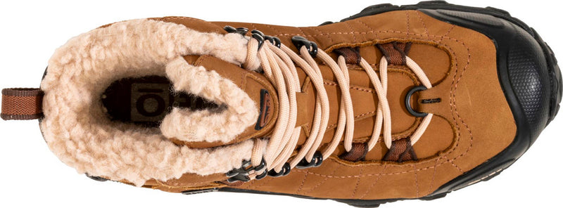 Top view of a brown shoe with black accents and white fur trim against a white background. 