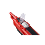 A close-up of a red toy blaster or toy gun with a transparent hinged lid open, revealing salt inside, on a plain white background.