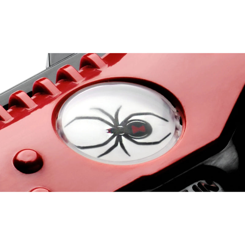 A close-up of a red device featuring a circular clear lens with a black spider graphic printed on it, resembling a spider-eye design.