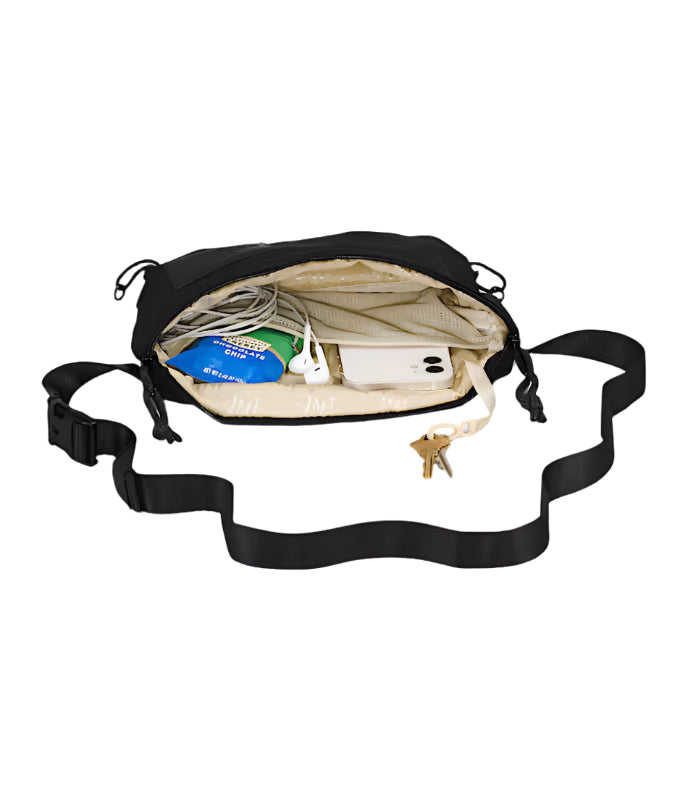 Black waist bag with items inside on a white background