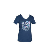 Women's Wildflower Relaxed Short Sleeve V-Neck Ashokan Rail Trail Tee in Darkest Blue. A cycling woman among a forest of larger-than-life wildflowers in pinks, purples, blues, and white is screenprinted on the front.