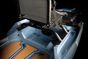 Close-up of a vehicle's open cargo area with a seat and tools inside, on a black background.