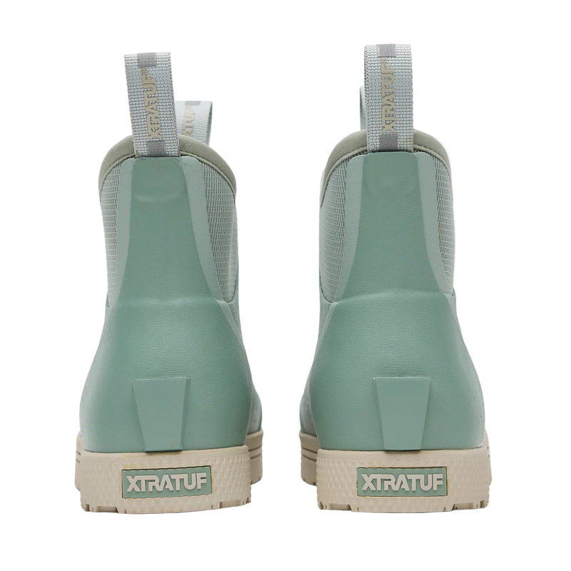 Pair of green Xtratuf boots shown from the back on a white background