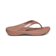 Side view of a pink sandal with a visible grey bottom against a white background. 